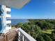 Balcony view of a waterfront with palm trees, boats, and city skyline in the distance on a clear day at 935 N Halifax Ave # 602, Daytona Beach, FL 32118