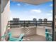 Enjoy ocean views from this balcony with teal chairs at 1 Oceans West Blvd # 16A4, Daytona Beach Shores, FL 32118