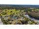 Aerial view of a residential community with houses, lake, and lush green landscape at 10 Ocean Pines Dr, Ormond Beach, FL 32174