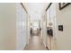 Long hallway leading to a double vanity bathroom with a shower and large mirror at 10 Ocean Pines Dr, Ormond Beach, FL 32174