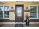 Elegant front door entrance with a welcoming mat and potted plant at 10 Ocean Pines Dr, Ormond Beach, FL 32174