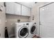 Laundry room with washer, dryer, and overhead storage at 10 Ocean Pines Dr, Ormond Beach, FL 32174