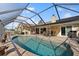 Inviting kidney-shaped pool with covered patio and seating at 10 Ocean Pines Dr, Ormond Beach, FL 32174