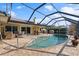 Large screened pool with patio furniture and lake views at 10 Ocean Pines Dr, Ormond Beach, FL 32174