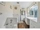 Bathroom with double vanity, white tile, and a bathtub at 1102 Rolling Acres Dr, Deland, FL 32720