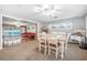 Charming dining room with a farmhouse table, white chairs, and views of the pool at 1102 Rolling Acres Dr, Deland, FL 32720