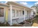 Welcoming front porch with white columns and brick exterior at 1102 Rolling Acres Dr, Deland, FL 32720