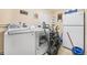 Functional laundry room with washer, dryer, and extra storage at 1102 Rolling Acres Dr, Deland, FL 32720