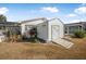 White storage shed with ramp access in backyard at 1102 Rolling Acres Dr, Deland, FL 32720