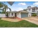 Single-story home with a green garage door and nicely landscaped front yard at 137 Avalon Dr, Ormond Beach, FL 32176