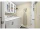 Convenient laundry room with washer, dryer, storage cabinets, and ironing board at 137 Avalon Dr, Ormond Beach, FL 32176