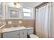 Bathroom with updated vanity and neutral tile at 1408 Ruthbern Rd, Daytona Beach, FL 32114