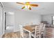 Bright dining area with wood table and chairs, wood-look flooring, and ceiling fan at 1408 Ruthbern Rd, Daytona Beach, FL 32114