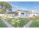 Backyard view of the house with a well-maintained lawn at 1408 Ruthbern Rd, Daytona Beach, FL 32114