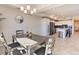 Bright dining area with table and chairs, adjacent to a modern kitchen at 3161 Paradox Cir # 303, Kissimmee, FL 34746