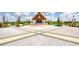 Outdoor entertainment stage with thatched roof, set in a beautifully landscaped area with seating at 329 Good Life Way, Daytona Beach, FL 32124