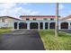 Three-car garage with dark brown doors and a paved driveway at 41 Ocean Palm Villa S # 41, Flagler Beach, FL 32136