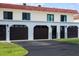 Three-car garage with dark brown doors and a paved driveway at 41 Ocean Palm Villa S # 41, Flagler Beach, FL 32136