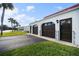 Two-car garage with dark brown doors and a paved driveway, side view at 41 Ocean Palm Villa S # 41, Flagler Beach, FL 32136