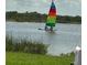 Sailboat on calm water with lush green banks and trees at 41 Ocean Palm Villa S # 41, Flagler Beach, FL 32136