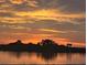 Stunning sunset over calm water with silhouetted trees at 41 Ocean Palm Villa S # 41, Flagler Beach, FL 32136