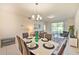 Bright dining area with seating for six, adjacent to the living room at 4741 Clock Tower Dr # 105, Kissimmee, FL 34746