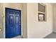 Building entrance with a blue door, well-lit at 4741 Clock Tower Dr # 105, Kissimmee, FL 34746