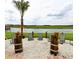 Relaxing lakefront view with sandy beach and lounge chairs at 4741 Clock Tower Dr # 105, Kissimmee, FL 34746