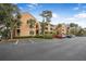 Condo building with parking and landscaping in a sunny setting at 1401 S Palmetto Ave # 618, Daytona Beach, FL 32114