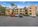 Front view of condo building showcasing its light color and parking at 1401 S Palmetto Ave # 618, Daytona Beach, FL 32114