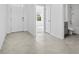 Bright entryway with tile flooring, leading to a bathroom and living spaces at 1702 Myrtlebrooke Dr, Edgewater, FL 32141