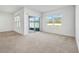 Bright living room with sliding glass doors leading to a patio at 1702 Myrtlebrooke Dr, Edgewater, FL 32141