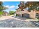 Brick driveway leading to a charming, two-story home with multiple garages at 2627 John Anderson Dr, Ormond Beach, FL 32176