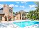 Brick home with a large pool and beautifully landscaped backyard at 2627 John Anderson Dr, Ormond Beach, FL 32176