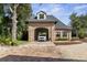 Brick garage with car and paver driveway at 2627 John Anderson Dr, Ormond Beach, FL 32176