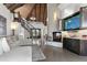 Living room with a stone fireplace, spiral staircase, and high ceilings at 2627 John Anderson Dr, Ormond Beach, FL 32176