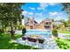 Inviting pool area with fire pit and lounge chairs, nestled in lush greenery at 2627 John Anderson Dr, Ormond Beach, FL 32176