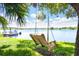 Relaxing wooden swing overlooking waterfront property at 2627 John Anderson Dr, Ormond Beach, FL 32176