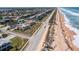 Aerial view of beachfront property, showcasing a house near the ocean at 3072 Ocean Shore Blvd, Ormond Beach, FL 32176