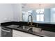 Modern kitchen sink with a gold faucet and dark countertop at 3072 Ocean Shore Blvd, Ormond Beach, FL 32176