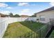 Fenced backyard with grassy area and storage shed at 35 Saddlers Run, Ormond Beach, FL 32174