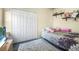 Cozy bedroom with a floral bedspread and built-in shelving at 35 Saddlers Run, Ormond Beach, FL 32174