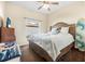 Bedroom with king-size bed, window, and surfboard decor at 35 Saddlers Run, Ormond Beach, FL 32174