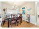 Bright dining room features hardwood floors, chandelier, and vintage furniture at 35 Saddlers Run, Ormond Beach, FL 32174