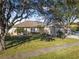 Tan house with a three-car garage and solar panels at 35 Saddlers Run, Ormond Beach, FL 32174