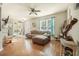 Living room with hardwood floors, sectional sofa, and ceiling fan at 35 Saddlers Run, Ormond Beach, FL 32174