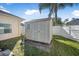 Tan storage shed in the backyard at 35 Saddlers Run, Ormond Beach, FL 32174