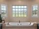 Relaxing bathroom with large soaking tub and glass block window at 38338 Timberlane Dr, Umatilla, FL 32784