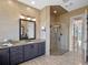 Elegant bathroom with double vanity and frameless shower at 38338 Timberlane Dr, Umatilla, FL 32784