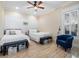 Guest bedroom with two twin beds and a blue armchair at 38338 Timberlane Dr, Umatilla, FL 32784